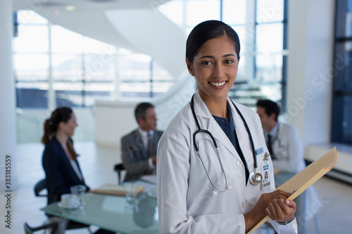 Portrait smiling female doctor in hospital meeting