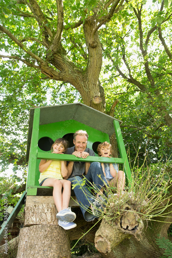 Portrait happy father and kids in treehouse Stock Photo | Adobe Stock