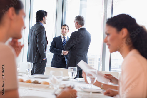 Corporate business people talking at conference luncheon