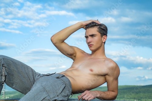 Shirtless athletic naked guy. Young man with sexy body.