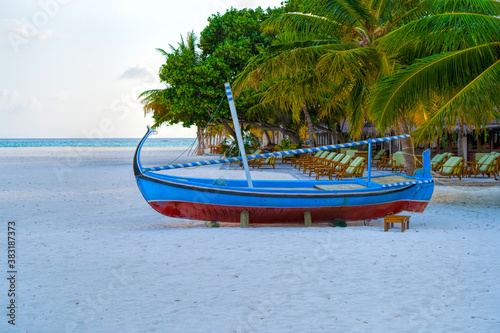 View of nice tropical beach with old boat