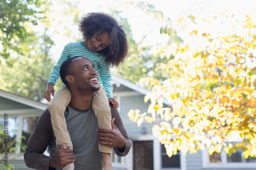 Photography Happy father carrying daughter on shoulders
