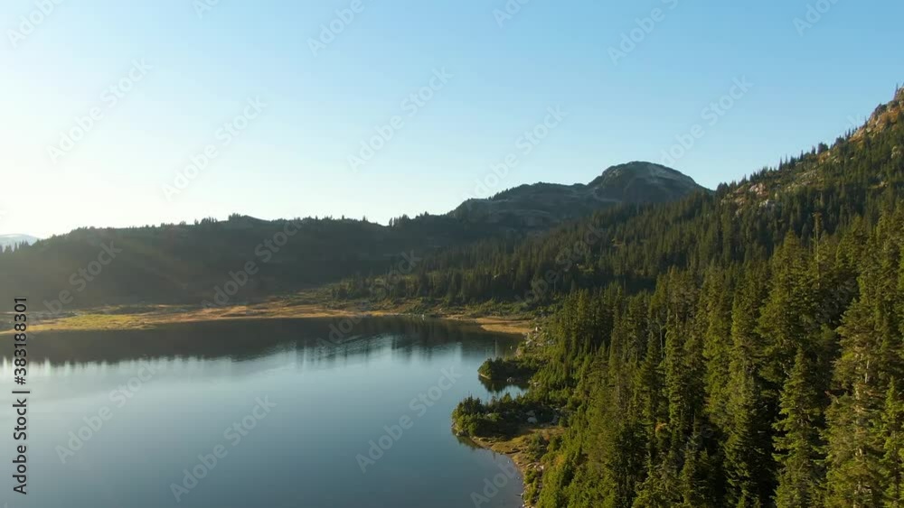 Aerial View of Beautiful Glacier Lake in the Canadian Mountain Landscape. Blue Sunny Sunset Sky. Whistler, British Columbia, Canada. Nature Background Aerial View of Beautiful Glacier Lake in the Canadian Mountain Landscape. Blue Sunny Sunset Sky. Whistler, British Columbia, Canada. Nature Background