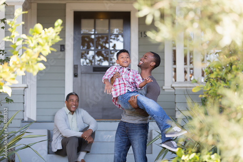 Happy multi-generation men on front stoop