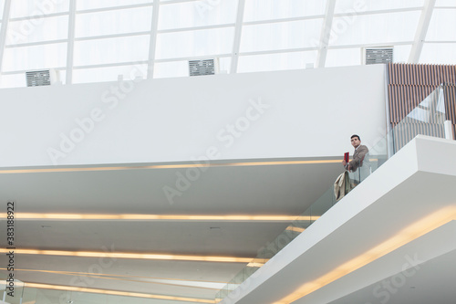 Vászonkép Businessman on modern office atrium balcony