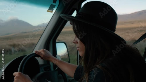 Attractive woman driving through beautiful countryside
