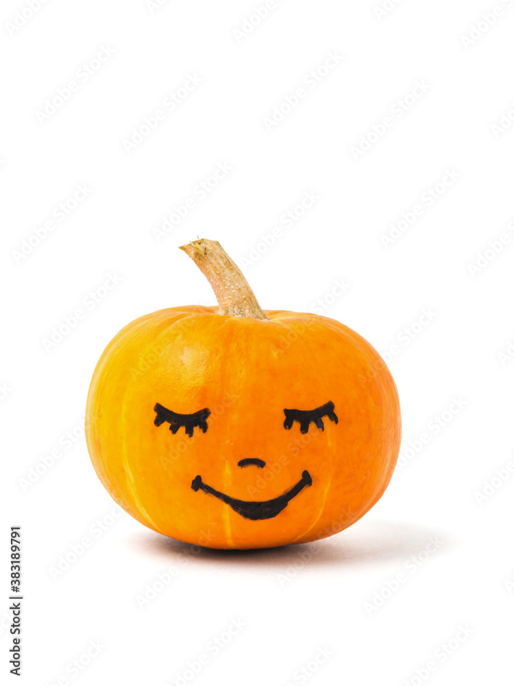 A ripe orange pumpkin with a painted face isolated on a white background. A ripe orange pumpkin with a painted face isolated on a white background.