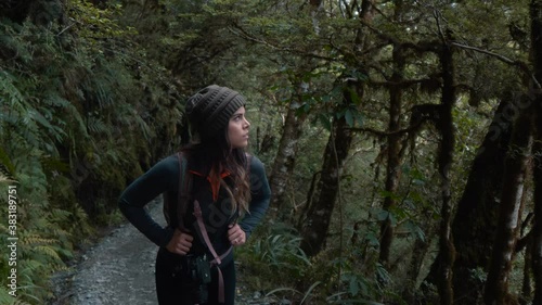 Woman hiking on green forest trail