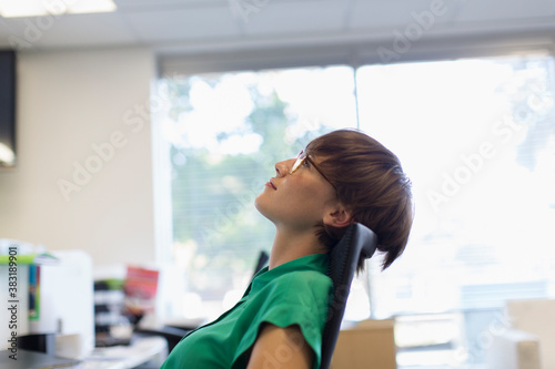 Businesswoman daydreaming and looking up in office