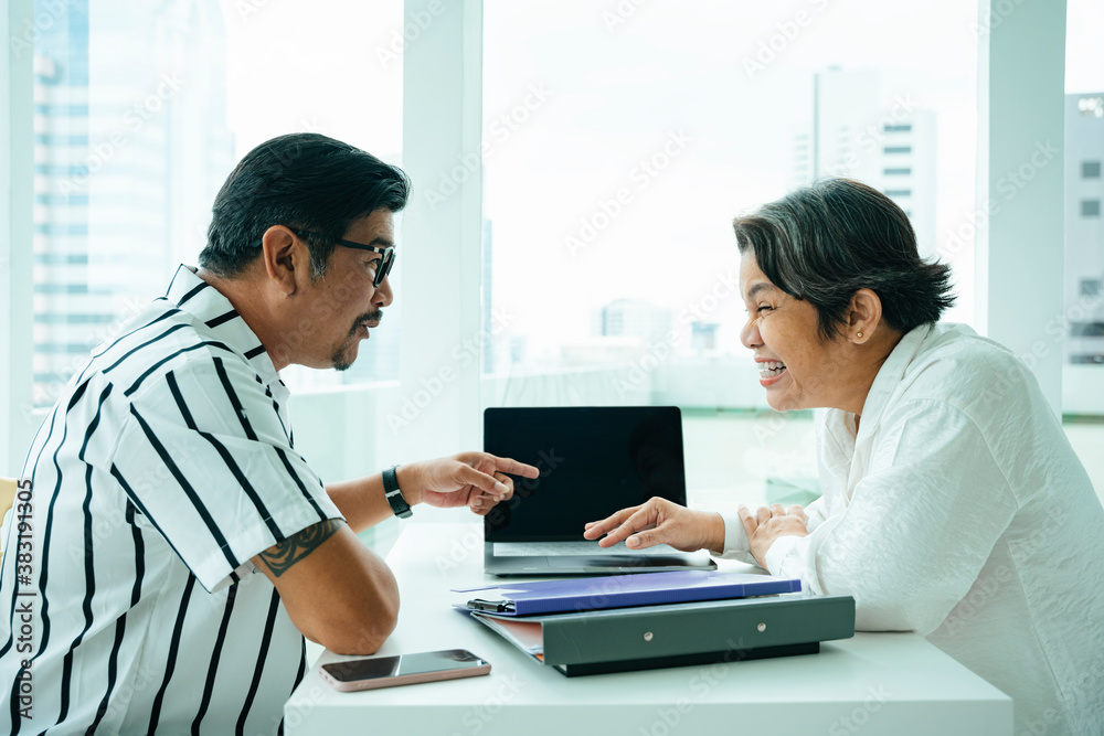 Asian business people working with partner together in office room. Asian business people working with partner together in office room.