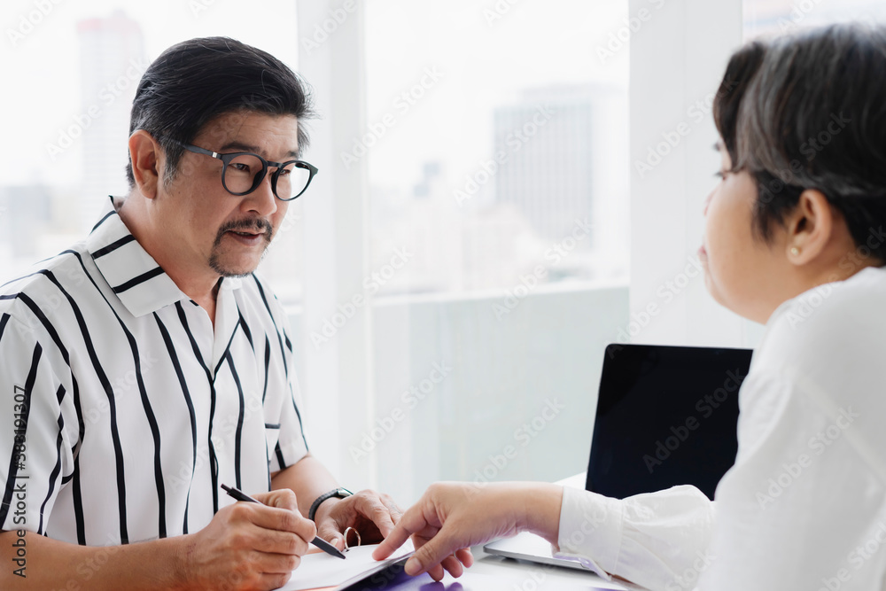 Adult businessman working with partner together in office room. Adult businessman working with partner together in office room.
