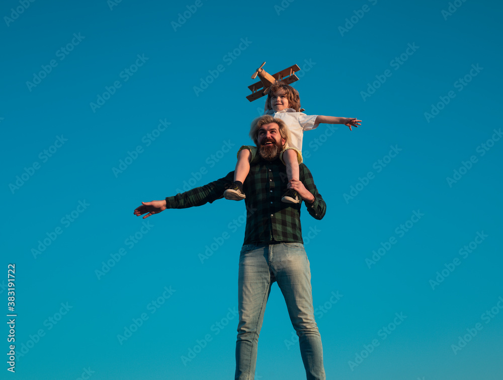 Success and child leader concept. Father and son playing with toy plane outdoor. Family holiday, parenthood. Fathers day. Success and child leader concept. Father and son playing with toy plane outdoor. Family holiday, parenthood. Fathers day.