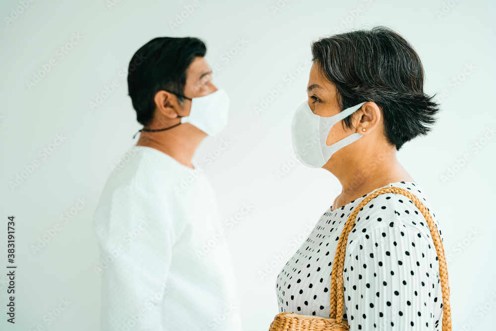 Elderly senior couple in white shirt wear mask isolate on background. Elderly senior couple in white shirt wear mask isolate on background.