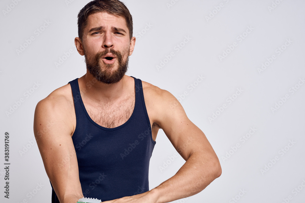 man with a massager in his hand and in a blue t-shirt spa treatments hygiene clean skin emotions model man with a massager in his hand and in a blue t-shirt spa treatments hygiene clean skin emotions model