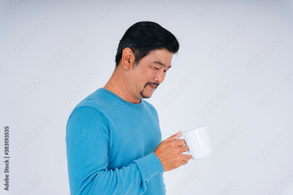 Senior man in blue long sleeve shirt with white coffee cup. Senior man in blue long sleeve shirt with white coffee cup.