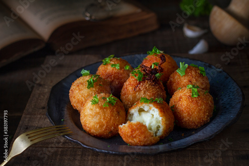 Traditional Italian arancini (rice balls with Mozzarella cheese) 