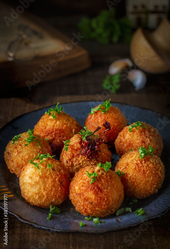 Traditional Italian arancini (rice balls with Mozzarella cheese)  photo