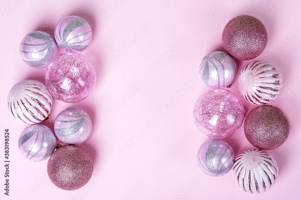 Fototapeta premium Christmas flat lay composition. Set of Christmas pink decorations, shiny balls on pastel background. Mock up for new year gretting card. Copy space for text or lettering