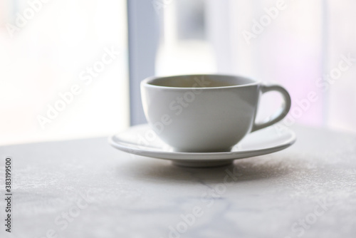 coffee cup on desk - black coffee in white mug on the table