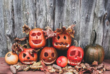 carved pumpkins with different faces are resting on a halloween party