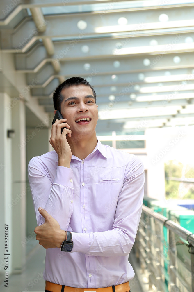 young south east Asian middle eastern man business office outdoor stand talk on phone