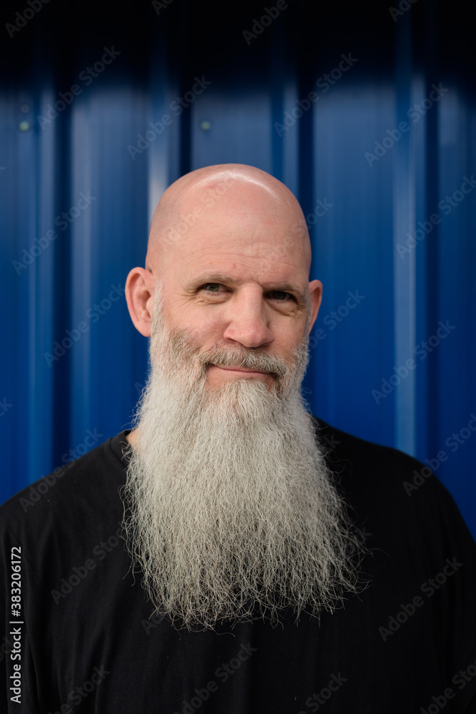 © Ranta Images - Face of mature handsome bald bearded man against metal sheet wall © Ranta Images - Face of mature handsome bald bearded man against metal sheet wall