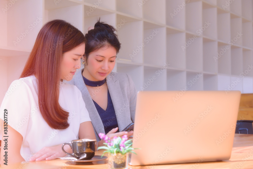 Two young girl enjoy working using laptop computer on the table. Two young girl enjoy working using laptop computer on the table.
