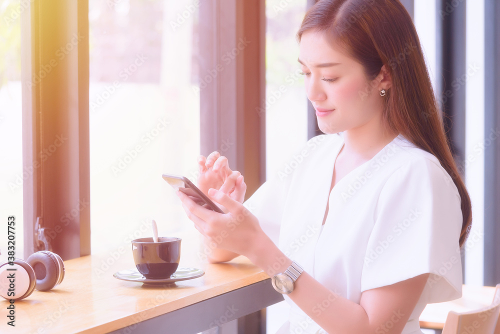 Young girl enjoy using smartphone sitting at modern workplace coffeeshop Young girl enjoy using smartphone sitting at modern workplace coffeeshop