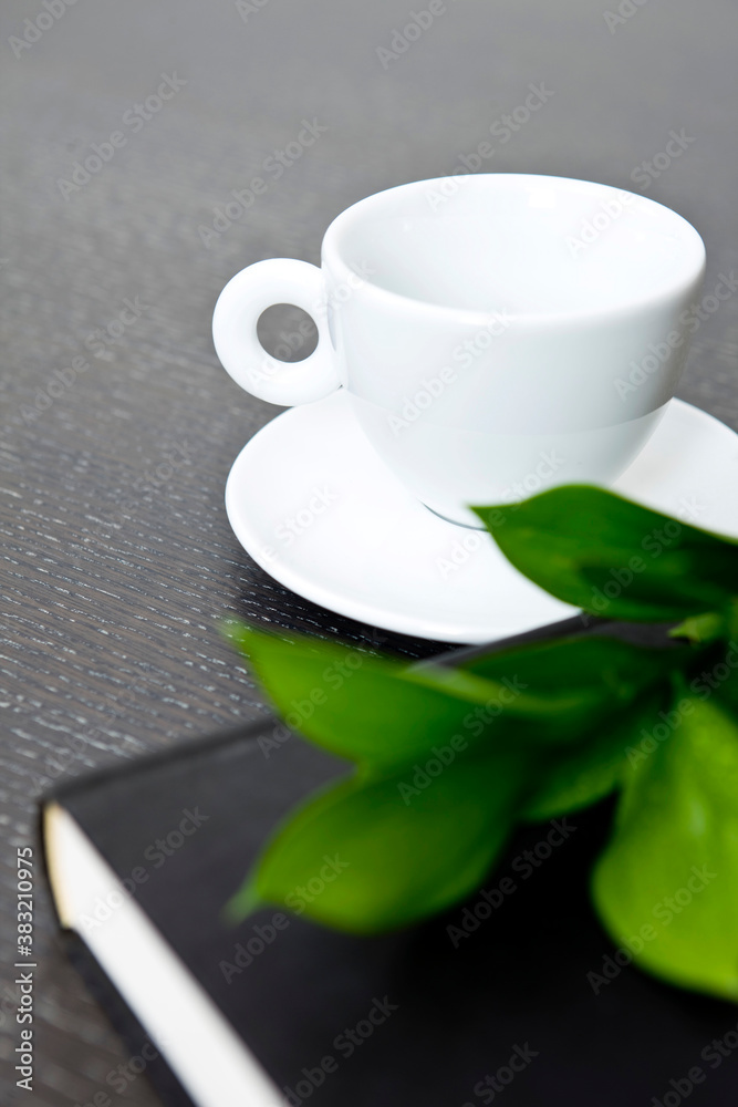 leaf on book, glasses and teacup leaf on book, glasses and teacup