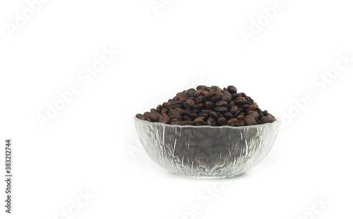 Roasted coffee beans in glass bowl isolated on white