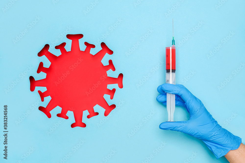 Hand in latex glove hold syringe with vaccine drug and abstract red coronavirus, virus, bacteria, microbe, blue background. Concept vaccination and infectious diseases, pandemic Covid -19 Hand in latex glove hold syringe with vaccine drug and abstract red coronavirus, virus, bacteria, microbe, blue background. Concept vaccination and infectious diseases, pandemic Covid -19