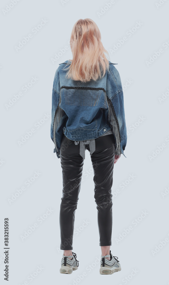 rear view. casual girl looking at blank white wall rear view. casual girl looking at blank white wall