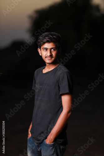 Young handsome indian boy wearing black t shirt