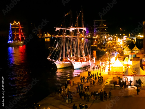 Photos Colorful lights on masts sailboats surrounding blurred