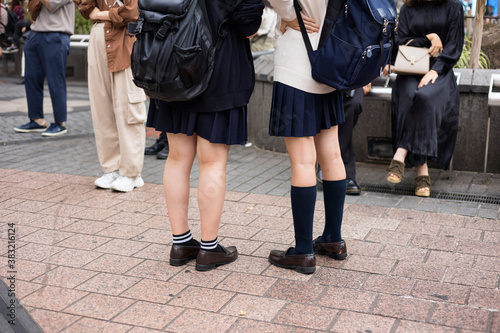 丈の短い紺ソックスと長い紺ソックスを履く女子高生たちの足元