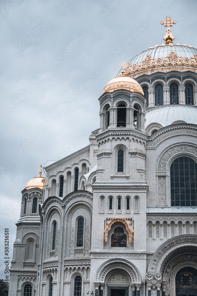 Kronstadt, Saint-Petersburg, Russia, 15 August 2020: Naval cathedral of Saint Nicholas on background of cloudy sky.