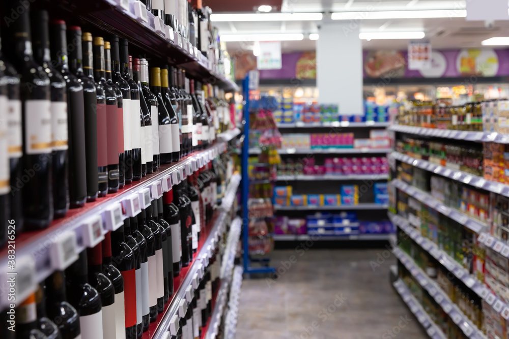 BARCELONA, SPAIN - NOVEMBER 07, 2019: Racks with red and white wine bottles in supermarket