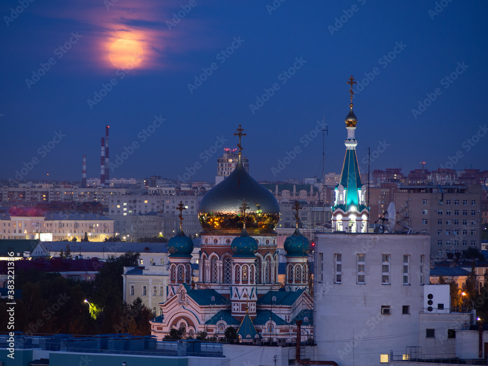 The rising full pink moon over the Assumption Cathedral in Omsk.