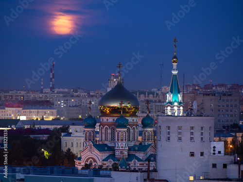 The rising full pink moon over the Assumption Cathedral in Omsk.