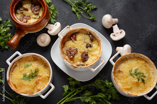 Potato gratin with mushrooms in baking cocottes