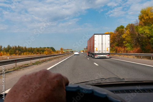 a truck driving on a highway on a bright autumn day