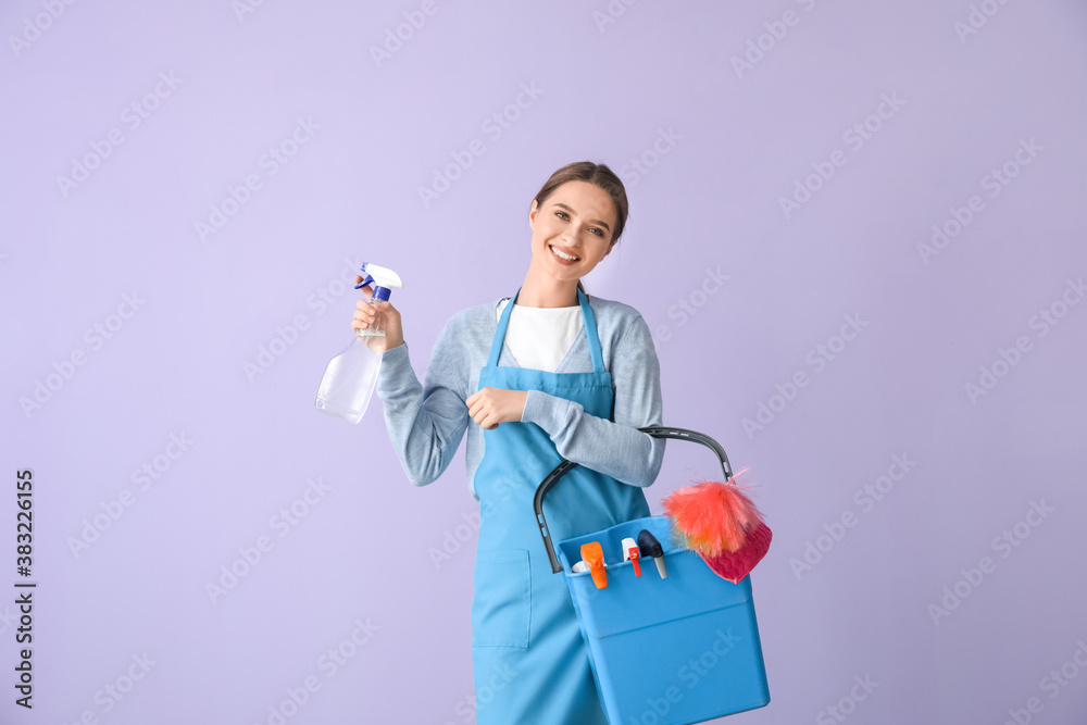 Young woman with cleaning supplies on color background Young woman with cleaning supplies on color background