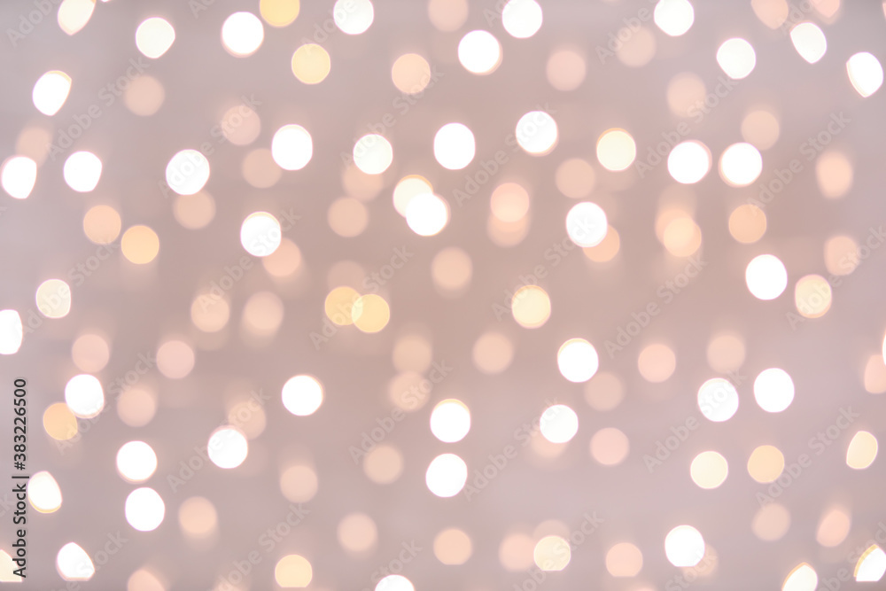 Blurred Christmas lights on grey background