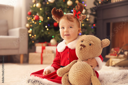 Adorable baby in reindeer a...