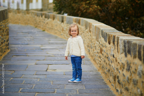 toddler girl walking on city wall in Saint-Malo, Brittany, France © Ekaterina Pokrovsky