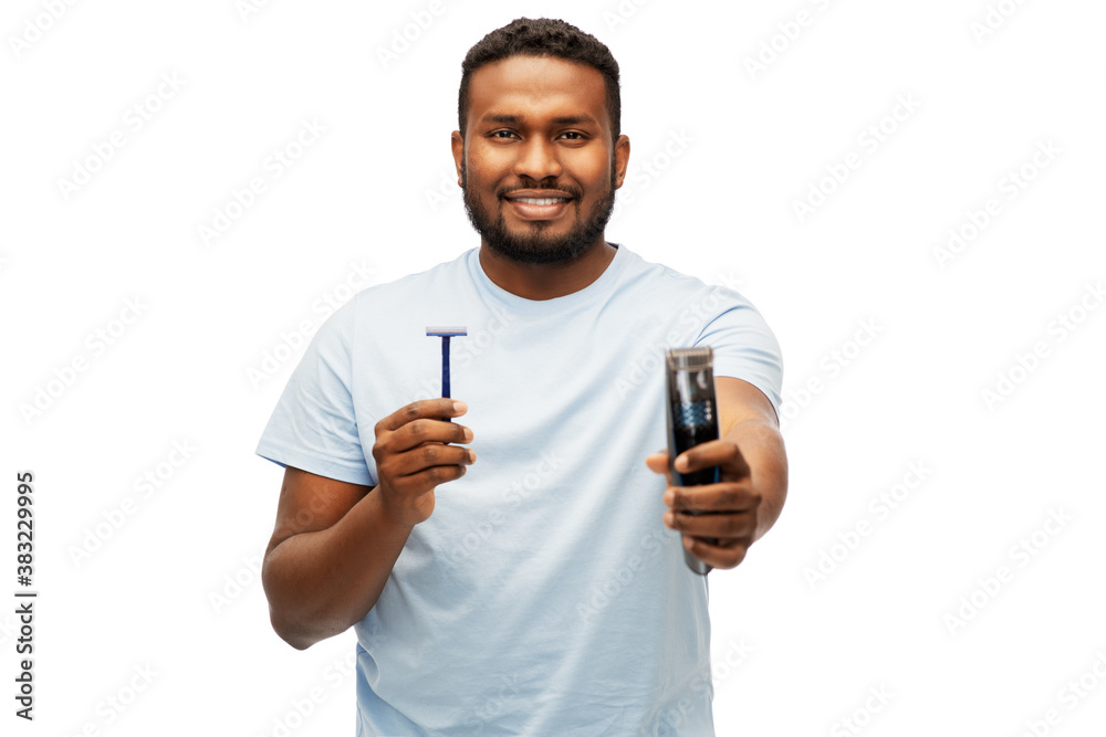shaving, grooming and people concept - smiling young african american man choosing between manual razor blade and trimmer over white background shaving, grooming and people concept - smiling young african american man choosing between manual razor blade and trimmer over white background
