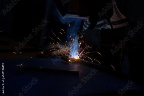 Sparks from metal welding. Welder to work. High temperature when working with a welding machine.