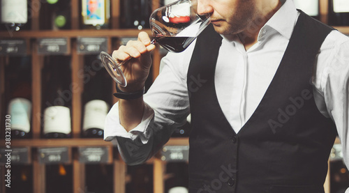 Quadro em tela Close up of sommelier man sniffing wine in glass