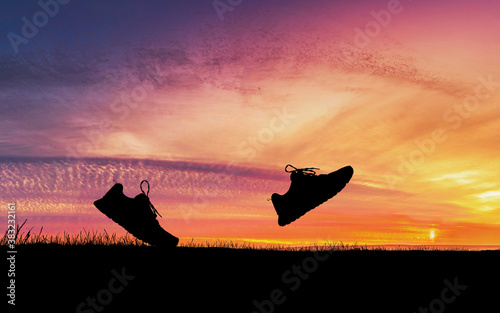Concept design for Trail running : Silluette running Shoe runnong along the track at the sunset time.