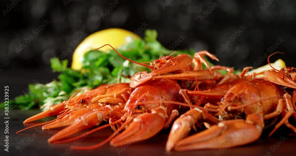 Boiled crayfish with herbs and lemon on the table rotate. Boiled crayfish with herbs and lemon on the table rotate.